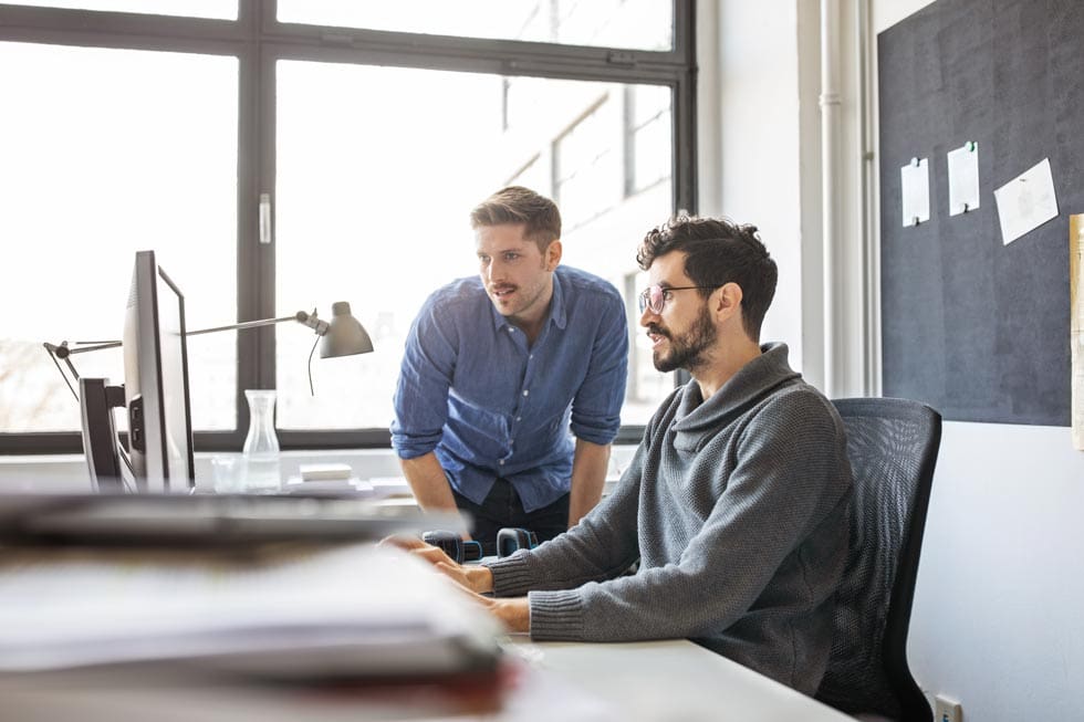 Business professionals working together on a computer